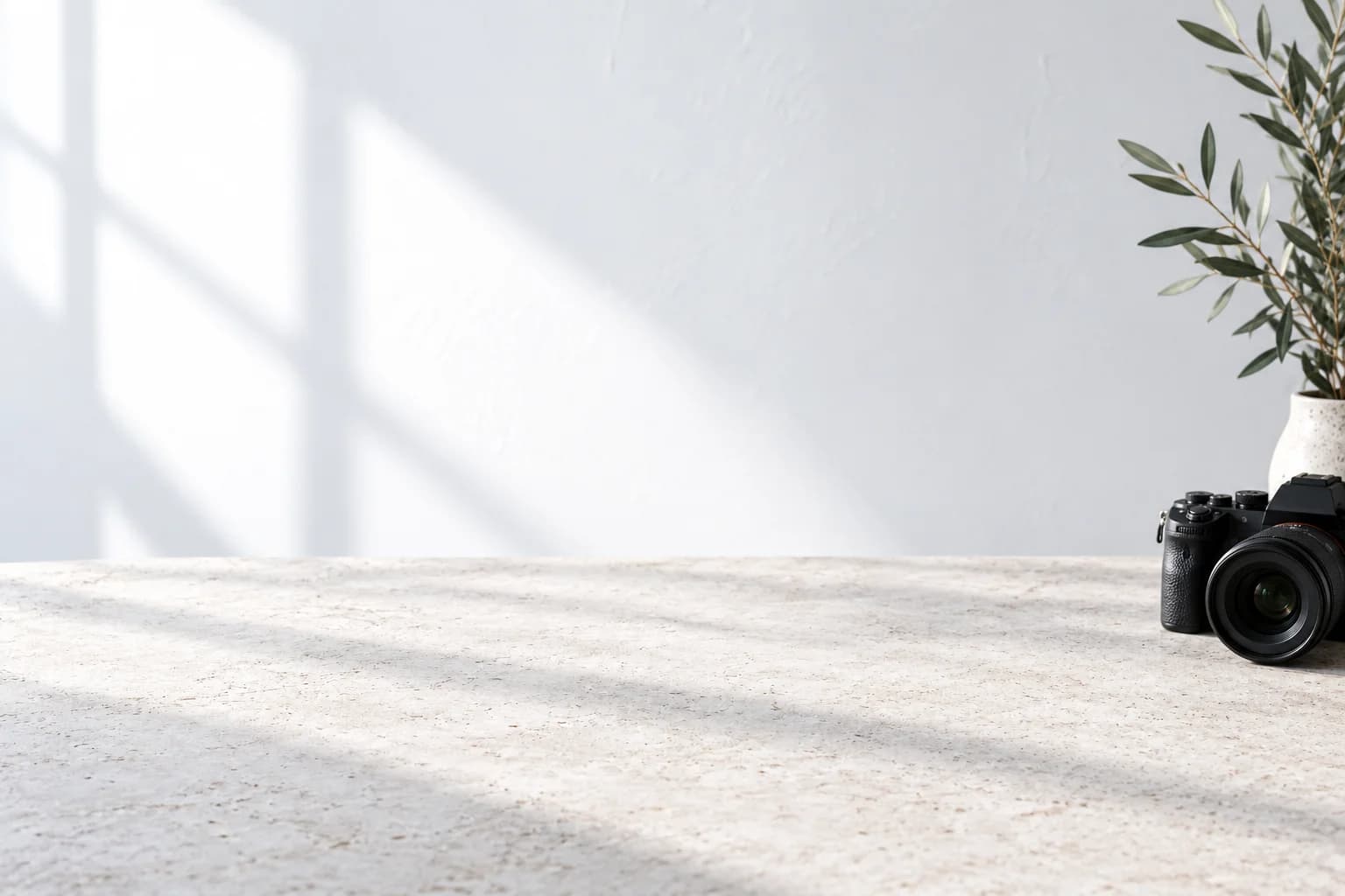 A sunlit creative workspace with campaign artwork displayed on the stone table