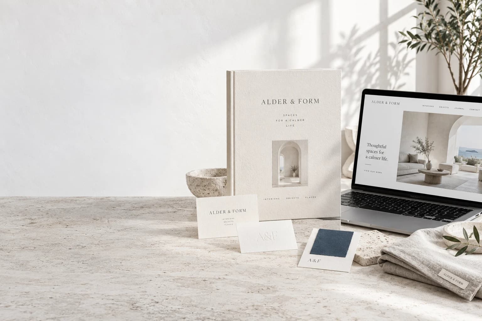 Illustrative Alder and Form brand identity with printed materials, colour samples and website on a studio table